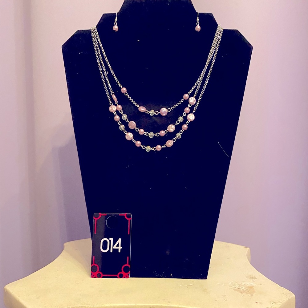 This is a beautiful pink three strand necklace with matching pink earrings.